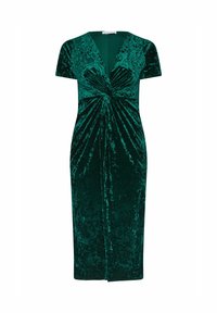 Zielona sukienka z aksamitu o głębokim dekolcie w kształcie V, krótkich rękawach i skręconym przodzie. Długość do kolan z dopasowaną sylwetką.