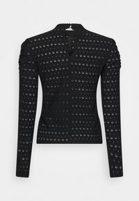 Svart långärmad topp med V-ringning, som har sammetsfulla axlar och ett strukturerat mönster av runda utskärningar genom hela tyget.