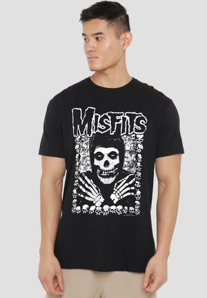 Black cotton t-shirt featuring a white graphic of a skull surrounded by skeleton hands and small skulls, with the word "Misfits" at the top.