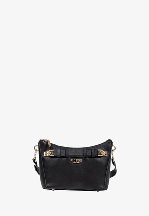 Sac à main en cuir synthétique noir avec un design structuré, des accents en métal doré, une fermeture éclair et une bandoulière amovible. Logo de la marque affiché.