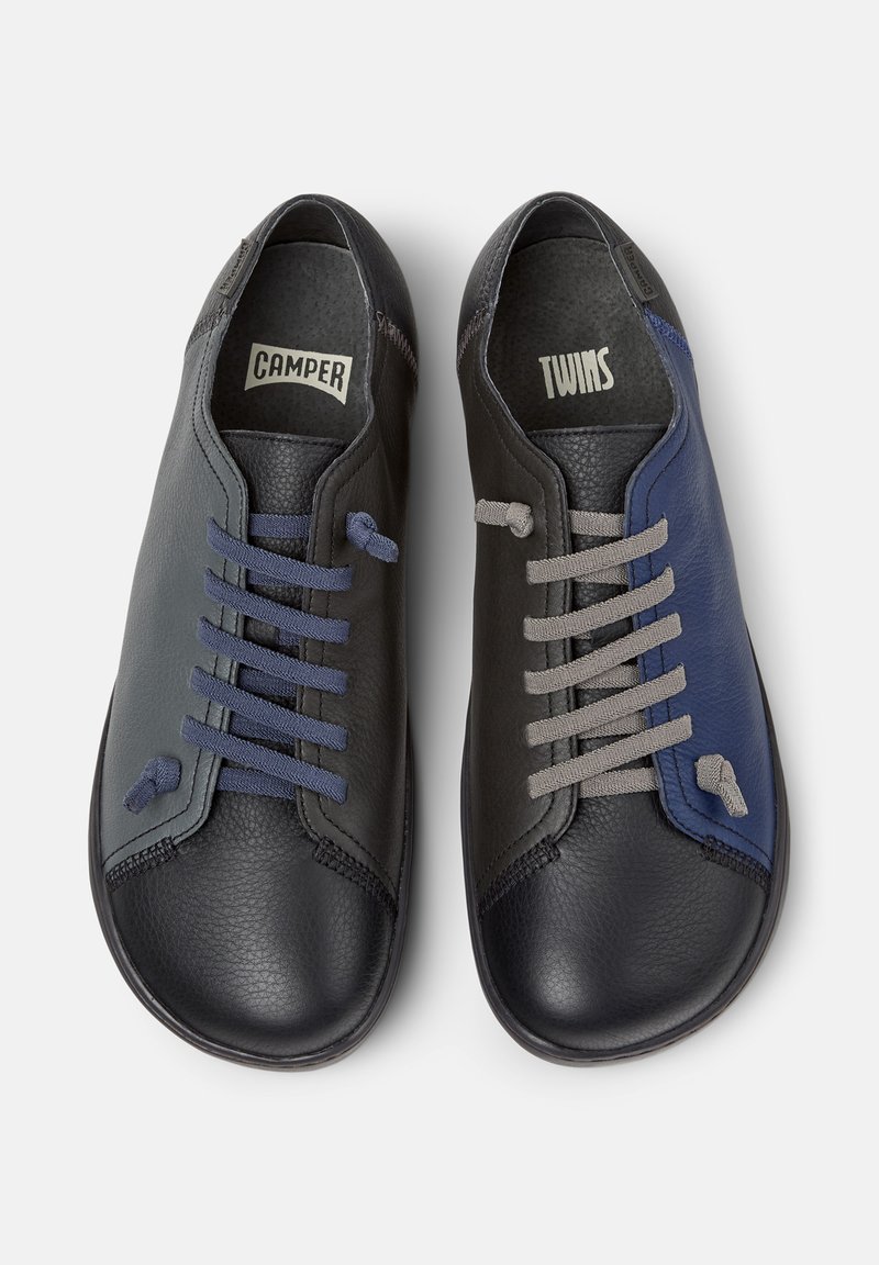 Black and navy leather shoes with contrasting laces, featuring a rounded toe and textured surface. "CAMPER" and "TWINS" labels inside.