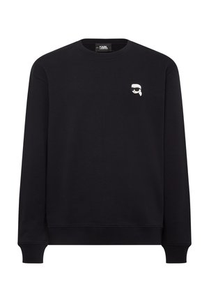 Black crew-neck sweatshirt made of cotton, featuring a small graphic of a face with sunglasses on the left chest. Ribbed cuffs and hem.