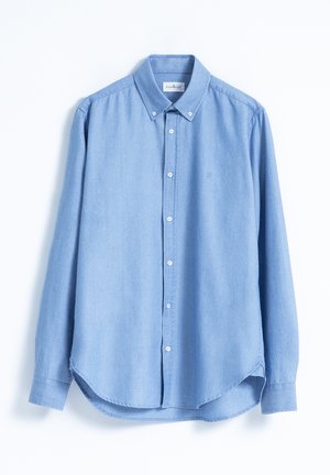 Camisa de botón de manga larga color azul claro, confeccionada en una tela ligera, con un cuello clásico y dobladillo redondeado. Pequeño logo en el lado izquierdo del pecho.