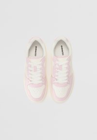 White and light pink sneakers with a smooth texture, round toe, perforations, and contrasting accents. Features white laces and branding inside.