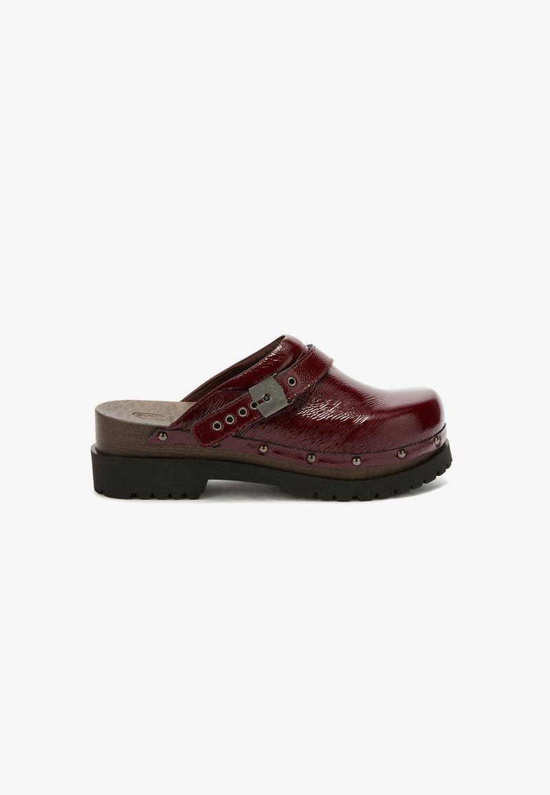 Clogs with a dark burgundy, glossy finish, featuring a wooden sole, adjustable strap, and metal hardware accents along the front.
