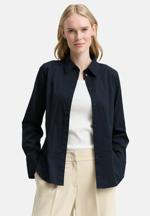 Navy button-up shirt with a collar, long sleeves, and a relaxed fit. Made from smooth fabric with a subtle sheen and no visible patterns.