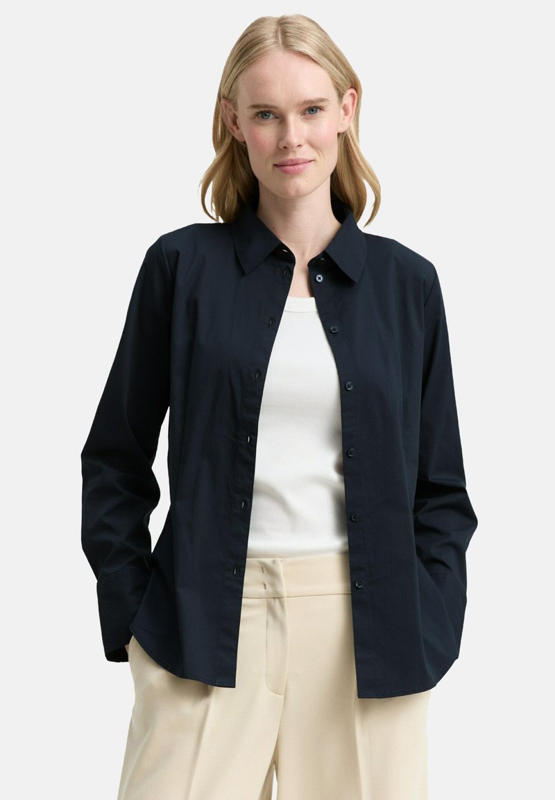 Navy button-up shirt with a collar, long sleeves, and a relaxed fit. Made from smooth fabric with a subtle sheen and no visible patterns.