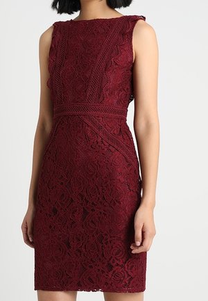 Robe en dentelle bordeaux sans manches avec motif floral et bordure texturée complexe sur le buste et la taille, silhouette cintrée.
