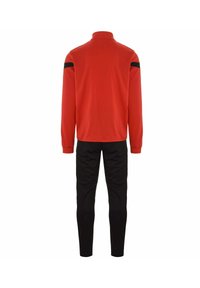 Rode zip-up trainingsjack met zwarte schouderaccenten en zwarte tapered broek. Glad materiaal, strakke manchetten en een hoge kraag.