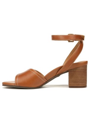 Brown leather block-heel sandal with an ankle strap, open toe, diagonal straps, and contrasting white stitching details.