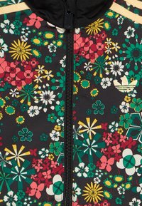 Μαύρο φλοράλ μπουφάν με φερμουάρ, διακοσμημέν ο με πολύχρωμα λουλούδια σε ροζ, κίτρινο και πράσινο, με υφή και λογότυπο σε χρυσή απόχρωση.