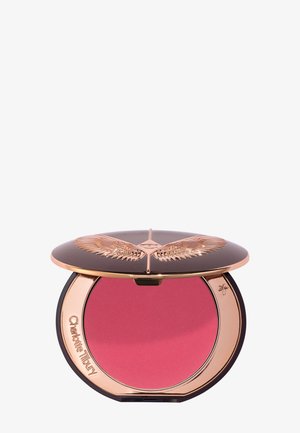 Round compact with rose gold winged lid and pink powder blush inside, engraved with "Charlotte Tilbury" on the inner rim.