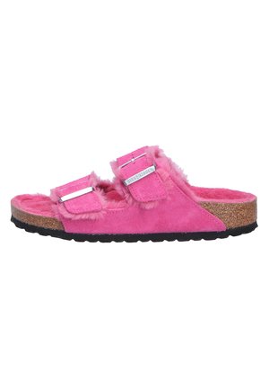 Fuzzy pink slide sandal with two adjustable straps, suede-like upper material, cork footbed, and textured black rubber outsole.