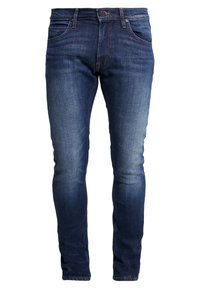 Mörkblå denimjeans med slim fit, utrustade med fem fickor, en knapp- och dragkedjestängning samt subtila blekningar på låren.