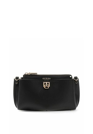 Sac à main noir Guess avec emblème logo doré, section supérieure zippée, et matériau à texture lisse, posé sur un fond blanc.