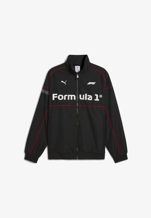 Veste légère noire avec des accents rouges, un col haut, une fermeture éclair et le logo "Formula 1" affiché en évidence sur le devant.