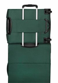 Valigia verde morbida con manico telescopico, doppie ruote nere e manico laterale ingrandito per il trasporto.