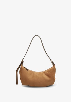 Tan suede handbag with a curved shape, brown leather strap, and zipper closure. Soft texture and minimalist design.