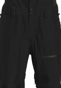 Black waterproof overalls with a fitted design, featuring adjustable straps, snap buttons, a front zipper pocket, and a smooth texture.