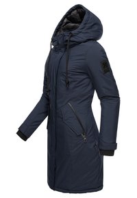Navy blue long parka jacket with a hood, featuring zipper pockets, elastic cuffs, and a textured fabric with a logo patch on the sleeve.