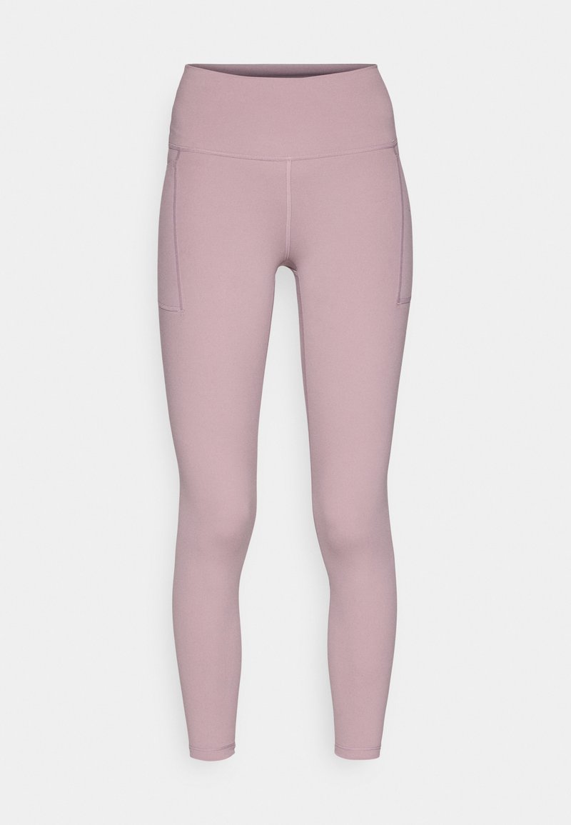 Leggings d'une douce couleur lavande discrète, dotés d'une taille haute et de deux poches latérales. Fabriqués en tissu lisse et extensible.