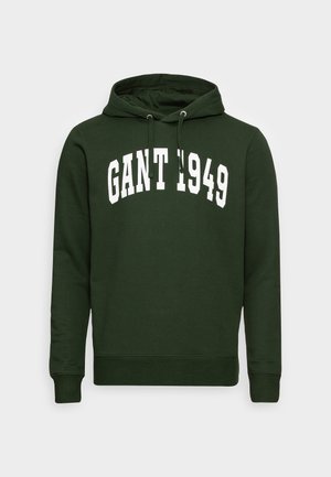 Kapuzensweatshirt aus dunkelgrünem Baumwollstoff, mit Kängurutasche und weißem "GANT 1949"-Grafik auf der Brust. Rippbündchen an den Ärmeln und am Saum.
