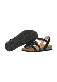 Černé sandály s korkovou mezipodešví, květinovým koženým akcentem, nastavitelnými pásky a texturovanou gumovou podešví. Obsahují otevřenou špičku a design podpatku.