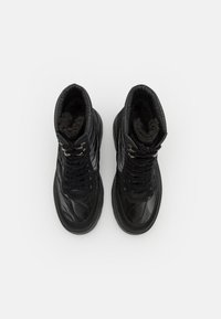 Botas altas negras hechas de cuero brillante con diseño acolchado, que cuentan con cordones negros, ojales plateados y forro texturizado.
