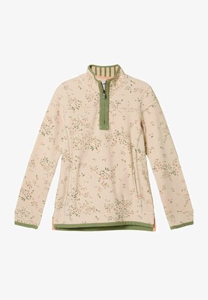 Pulover din material bej moale cu model floral verde. Prezintă un guler cu fermoar pe jumătate, mâneci lungi și tiv și manșete verzi.