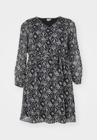 Μαύρο και κρεμ φόρεμα με μοτίβο, με V-λαιμόκοψη, μακριά μανίκια και ζώνη που δένει στη μέση. Ελαφρύ, ρέον ύφασμα με διαμαντένια μοτίβα.