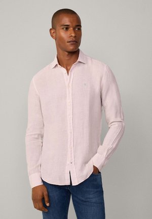 Light pink linen shirt with long sleeves, a button-down front, and a small blue logo on the chest; features a relaxed fit and soft texture.