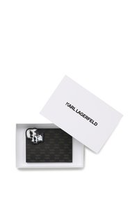 Black cardholder with embossed pattern, accompanied by a silver-tone skull accessory. Presented in a white rectangular box labeled "KARL LAGERFELD."