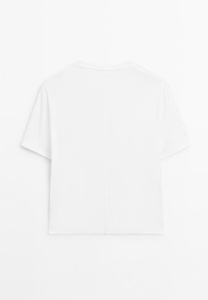 Short-sleeve, crew-neck white t-shirt. Soft texture with a straight cut and visible center seam on the back. No patterns or graphics.