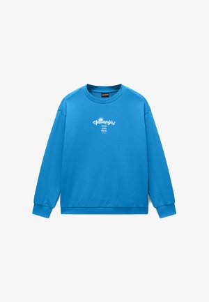 Niebieska bluza z okrągłym dekoltem i długimi rękawami, z białym napisem „Napapijri Make Your Mark” i grafiką słońca na środku klatki piersiowej.