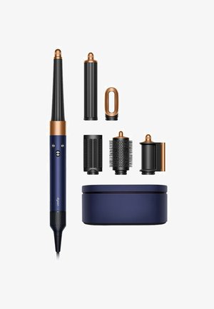 Set di strumenti per acconciature con impugnatura blu scuro, dettagli in rame, cilindri neri intercambiabili e custodia coordinata.