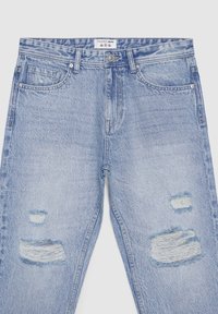 Jeans in denim azzurro chiaro con una vestibilità comoda, caratterizzati da sezioni consumate, bordi sfrangiati e il classico design a cinque tasche. Accenti in ottone.