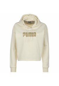 Zkrácená krémová mikina s kapucí vyrobená z měkké látky, s velkým zlatým logem "PUMA" a šňůrkami na kapuci. Rybí manžety.