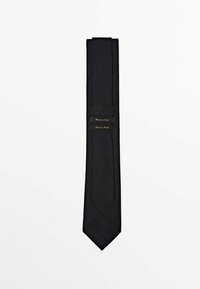 Black silk tie with a smooth texture. Features a pointed tip and two black labels with gold text, indicating brand and origin.