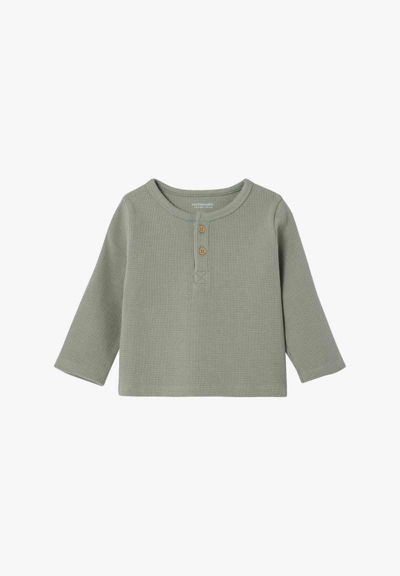 Green long-sleeve shirt in a textured waffle knit, featuring a rounded neckline, two wooden buttons at the front, and a relaxed fit.