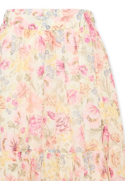 Jupe plissée douce avec motif floral pastel rose, jaune et bleu sur un fond crème clair.
