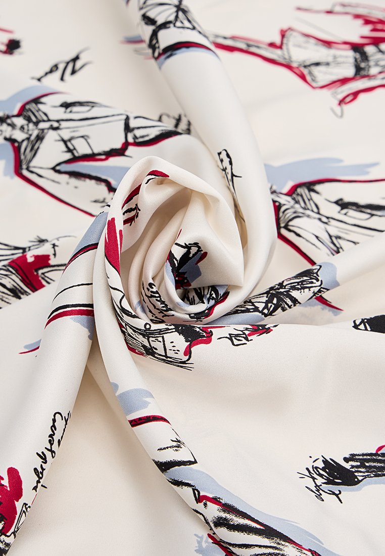 Tessuto di colore crema con una consistenza liscia, caratterizzato da un motivo di schizzi neri, rossi e azzurri di figure e forme astratte.