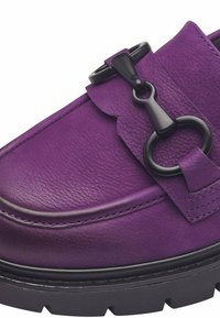 Purple leather loafer featuring textured upper, black hardware accent, and chunky black sole with a slight tread for grip.