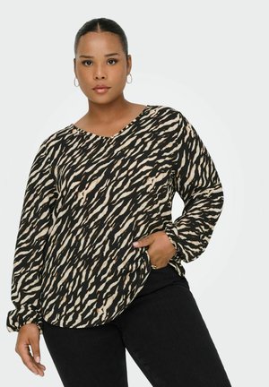 Blusa a maniche lunghe con un motivo astratto nero e beige, scollatura a V e vestibilità rilassata. Il materiale sembra morbido con una leggera lucentezza.