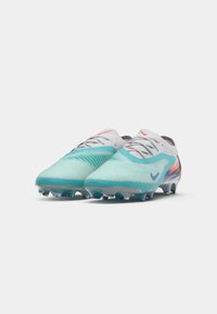 Nike football boots with a light aqua upper, textured design, grey accents, and transparent studs. Features a pink swoosh and branding.