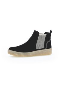 Stivale alla caviglia Chelsea nero con pannello elastico testurizzato beige, linguetta sul tallone, cuciture bianche e suola in gomma traslucida rigata.
