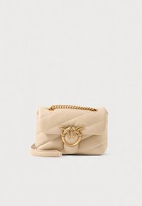 Beige quilted leather bag featuring a gold chain strap and a circular clasp with dual bird motifs. Compact design with smooth texture.