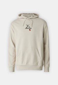 Felpa beige con tasca a canguro frontale, cappuccio con coulisse e testo "New Era" nero sotto una libellula e sopra un grafiche di una coccinella rossa.