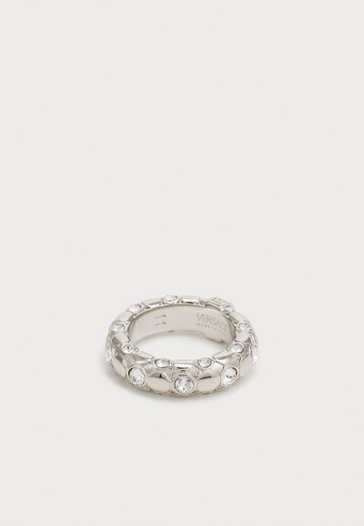 Silver ring with hexagonal shapes, embellished with clear gemstones, featuring a smooth band and engraved details on the inner side.