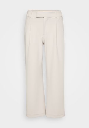 Beidzas platā kāju bikses, izgatavotas no mīksta auduma ar gludu tekstūru. Ar plakanu vidukli un diviem priekšējiem krokām.