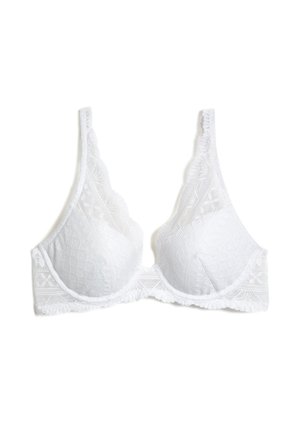 Soutien-gorge en dentelle blanche avec une forme triangulaire, des bords festonnés et des motifs floraux texturés. Bretelles ajustables avec une finition lisse.